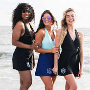 three girls wearing monogramed swim dress on beach