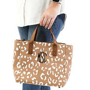 Monogrammed Crossbody Purse held by the handles