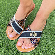 leopard and monogrammed criss cross sandals on grass