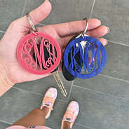 pink and blue acrylic monogrammed keychain in hand