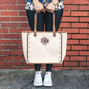 monogrammed khaki canvas tote in hands