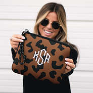 girl holding hickory leopard neoprene wristlet