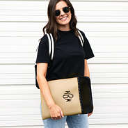 girl holding tan monogrammed neoprene laptop case