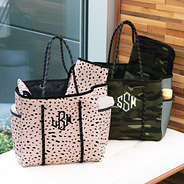 monogrammed neoprene diaper bag in camo and blush safari on bench