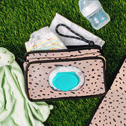 flatlay of neoprene diaper changing carryall - blush safari