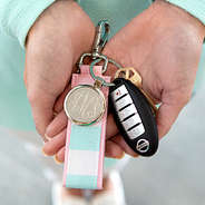 close up of cabana stripe keychain in hands