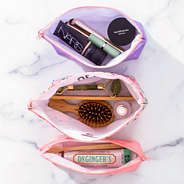 open cosmetic bags on counter - coral floral