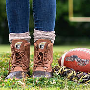 anderson duck boots with brown socks on football field