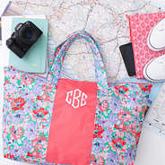 coral botanical packable weekend duffel over map