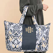 close up of gray ikat monogrammed packable weekend duffle bag