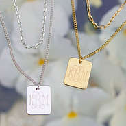 flatlay of layered pendant necklaces - gold and silver