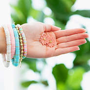 holding daisy earrings