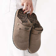 mocha monogrammed clogs in hands