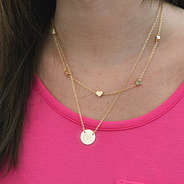 gold layered heart necklace on brunette