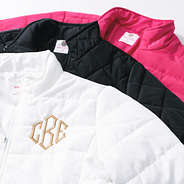 black white and hot pink monogrammed puffer jackets upclose