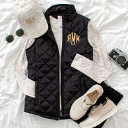 monogrammed puffer vest styled with baseball hat and sneakers