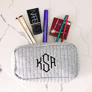 gray quilted cosmetic bag spill shot