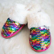 Sequin slippers on fur rug