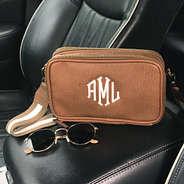 personalized crossbody bag in brown leather with striped strap in car