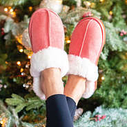 pink sherpa slippers in front of tree