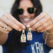 girl holding rose all day earrings