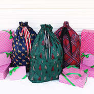 present sacks in festive christmas tree forest tartan plaid and puppy party with presents