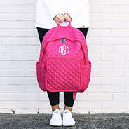 hot pink quilted laptop backpack in hands