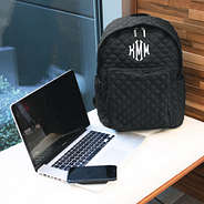 Monogrammed Quilted Laptop Backpack at desk