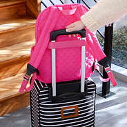 Hot Pink Quilted Laptop Backpack on top of Suitcase