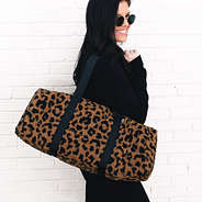 sherpa hickory brown leopard duffel bag over shoulder