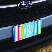 bright striped monogrammed license plate on blue subaru