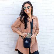 black-quilted-phone-crossbody-in-front-of-brick-wall