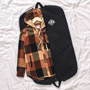 diamond quilted garment bag laying flat with shacket inside