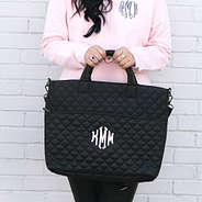 black quilted laptop bag in hands