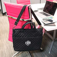 black quilted laptop bag on chair