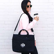monogrammed quilted laptop bag on shoulder