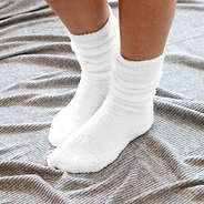 cozy socks in ivory walking on blanket