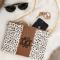 monogrammed leopard canvas clutch with sunglasses phone and fur