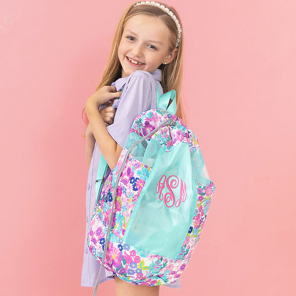 girl with mint oopsie daisy monogrammed beach backpack bag over shoulder