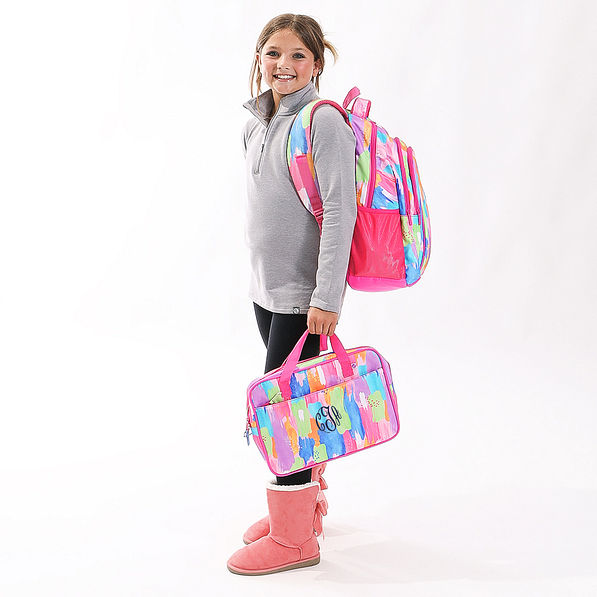 youth girl wearing multi paintbrush backpack and laptop bag