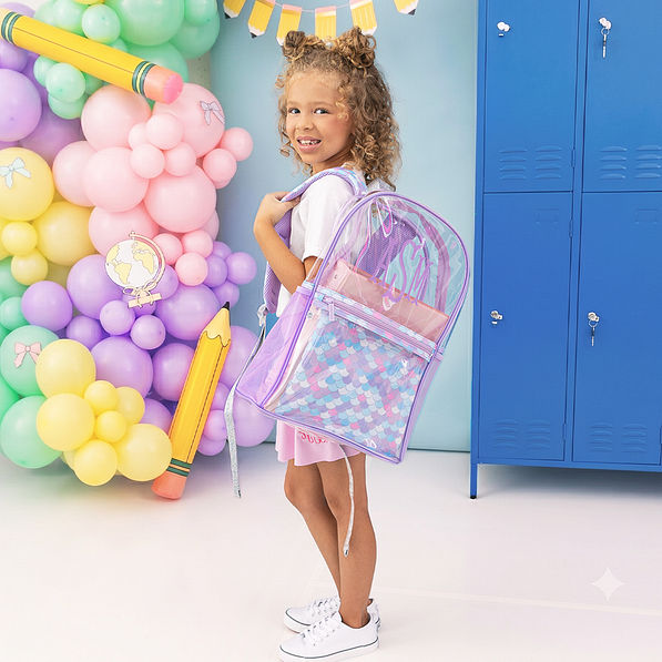 girl carrying mermaid magic monogrammed clear backpack