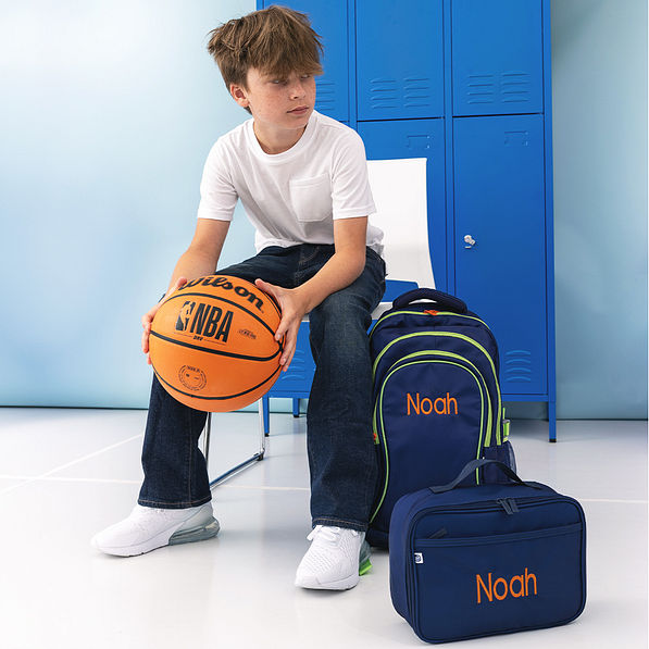 boy with monogrammed navy backpack and lunch box