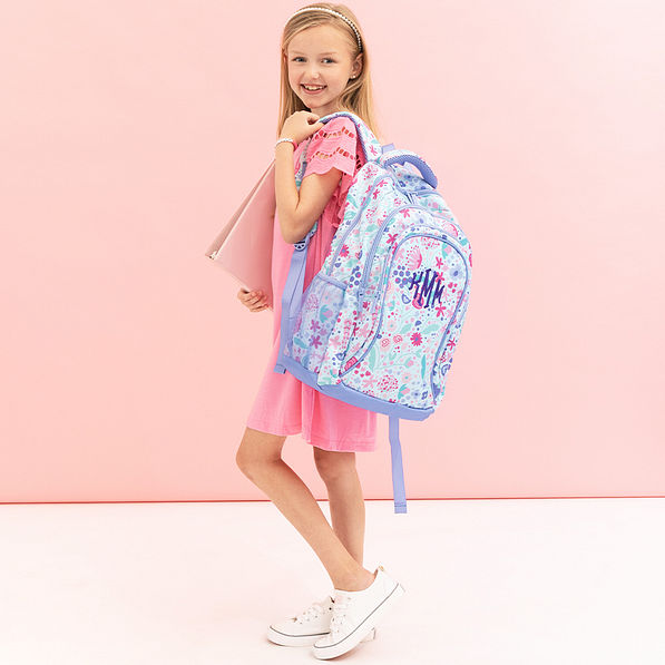 girl with monogrammed lavender blooms backpack over shoulder