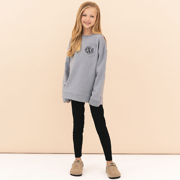 girl wearing heathered grey monogrammed crewneck sweatshirt