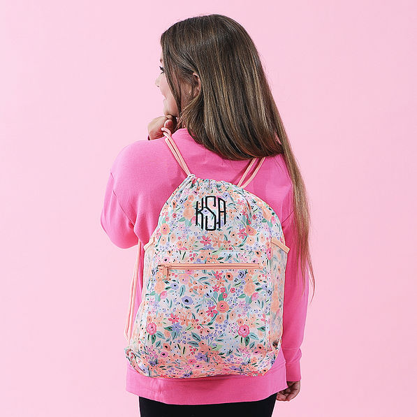 girl wearing coral floral cinch bag