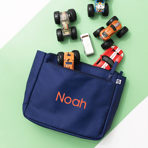 navy kids essentials pouch on green background