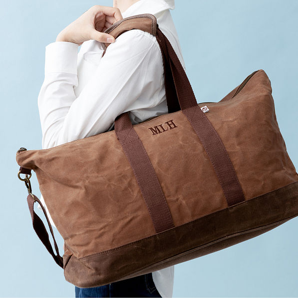 kids waxed canvas weekender on shoulder