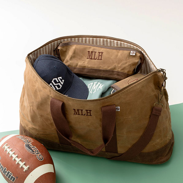 inside of waxed canvas weekender with dopp kit and wallet