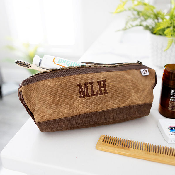 monogrammed waxed canvas dopp kit on bathroom counter