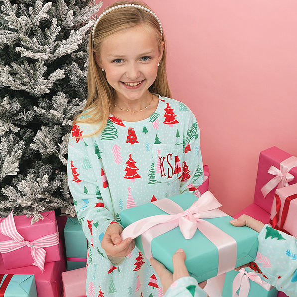girl wearing monogrammed mint wonderland nightgown with present